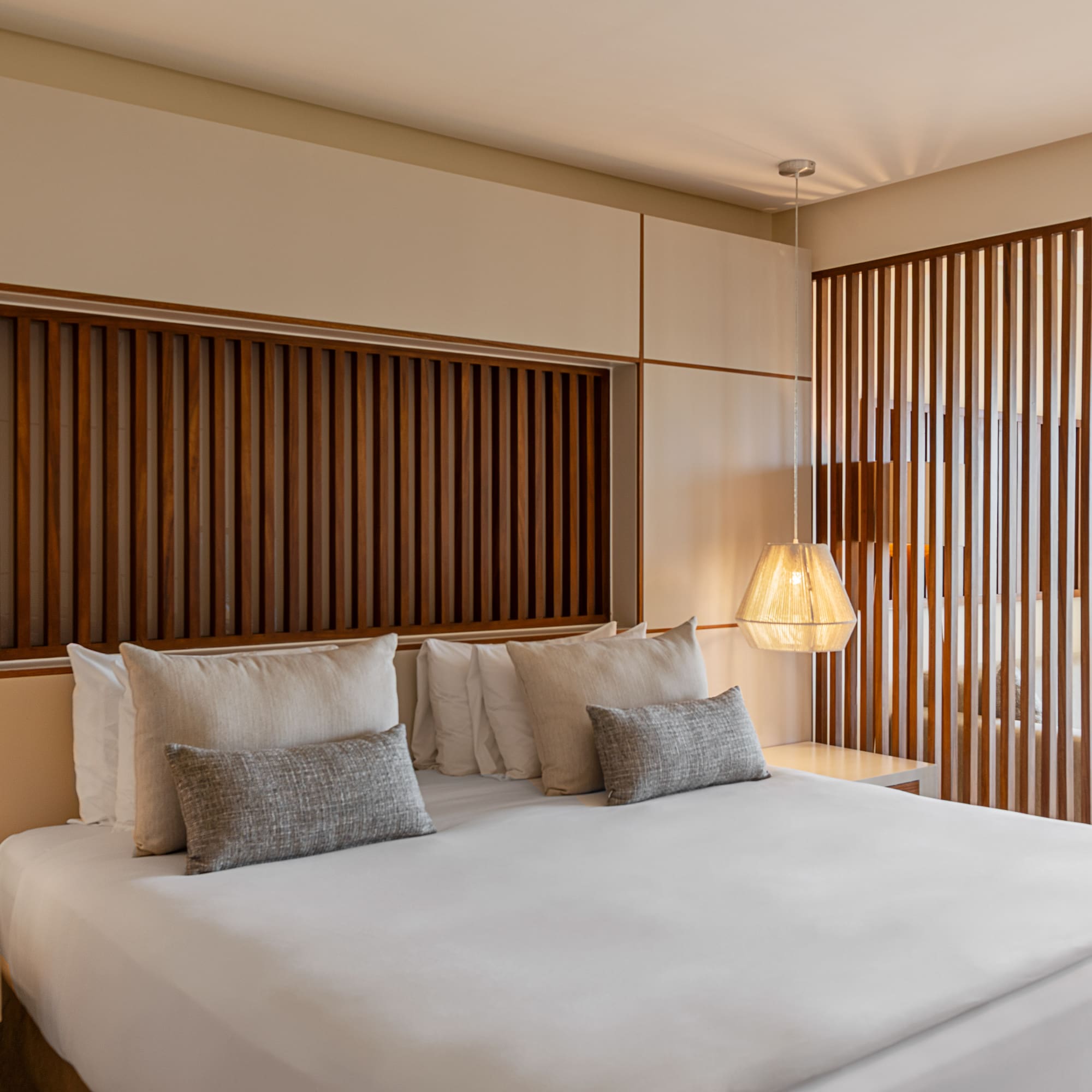 a bed with pillows and lamps in a room