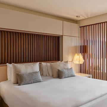 a bed with pillows and lamps in a room