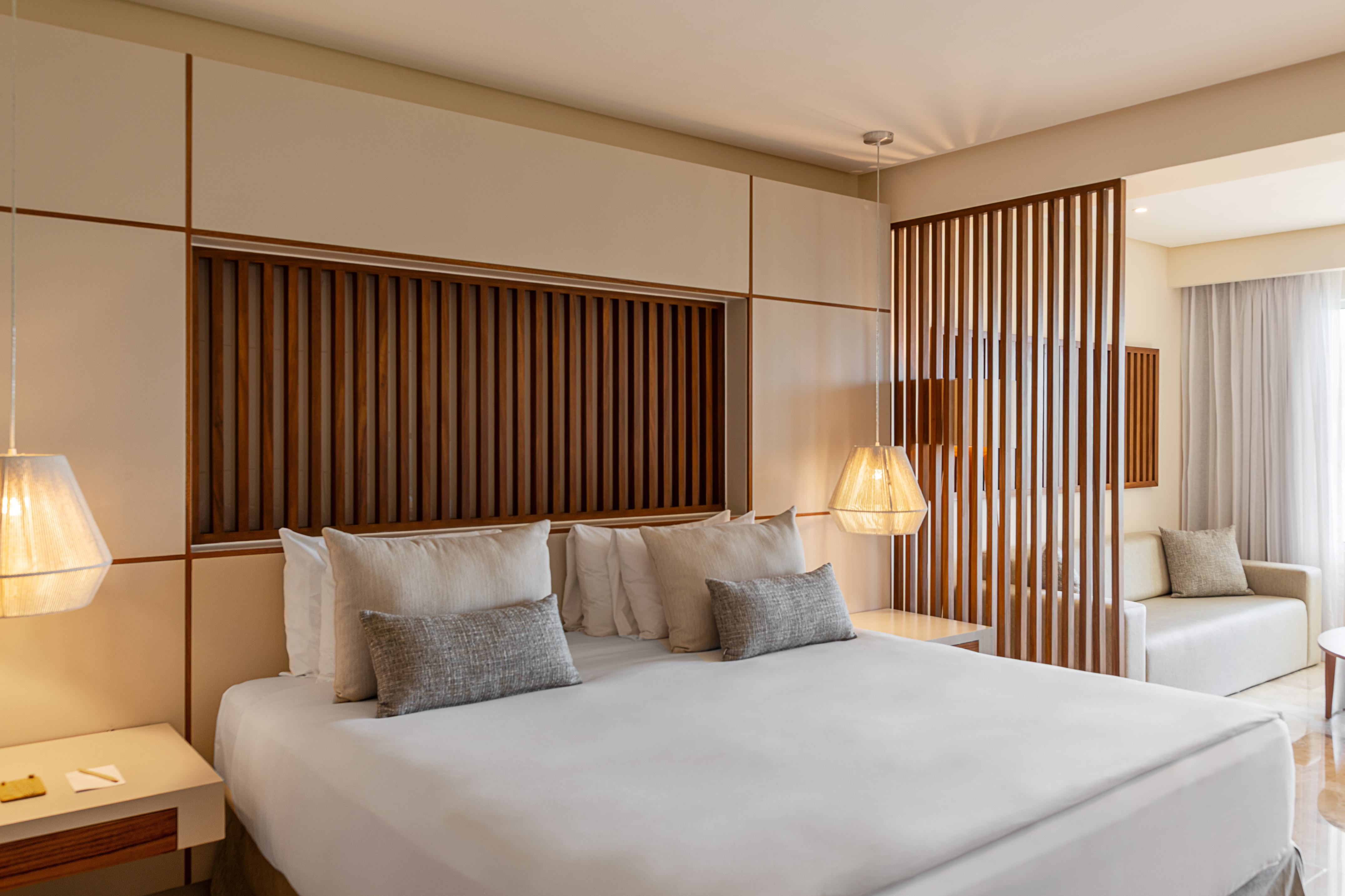 a bed with pillows and lamps in a room