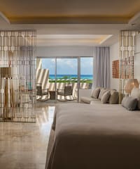 a room with a bed and a table and chairs