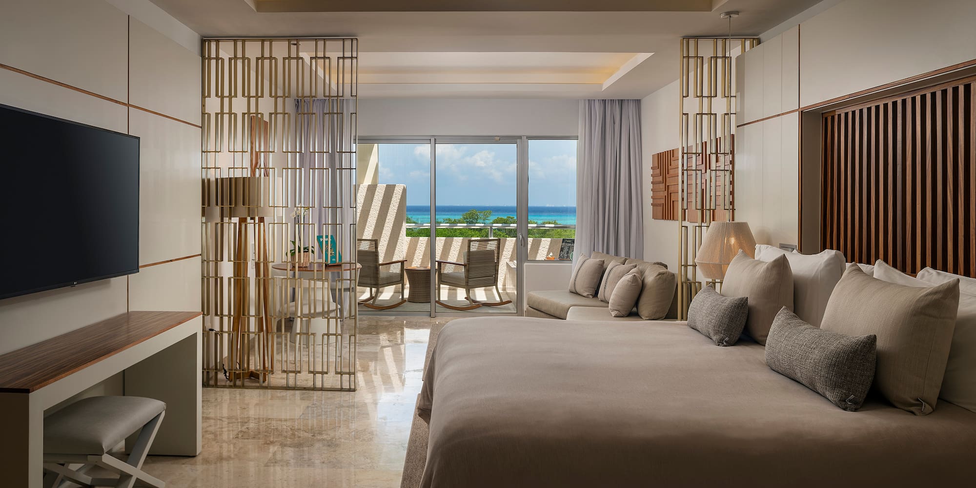 a room with a bed and a table and chairs