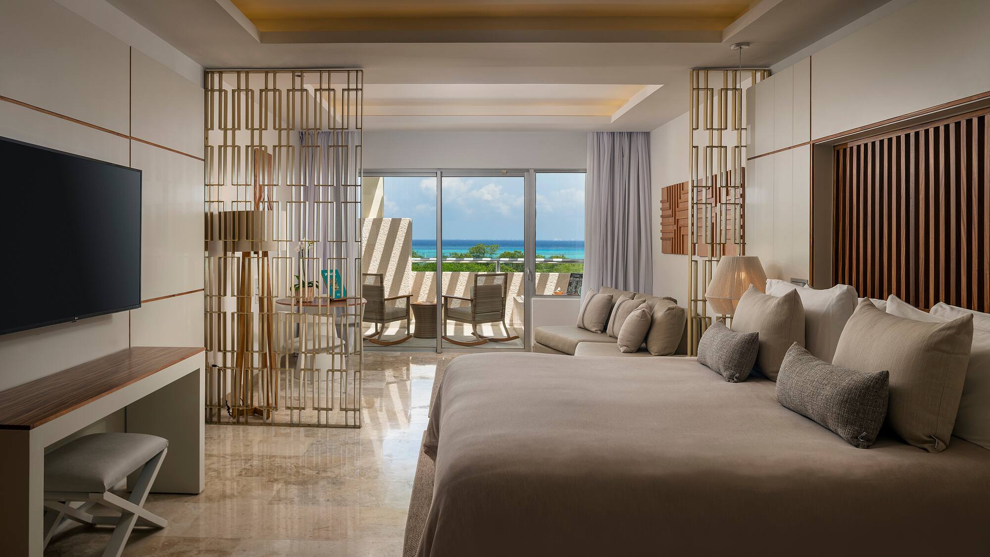 a room with a bed and a table and chairs