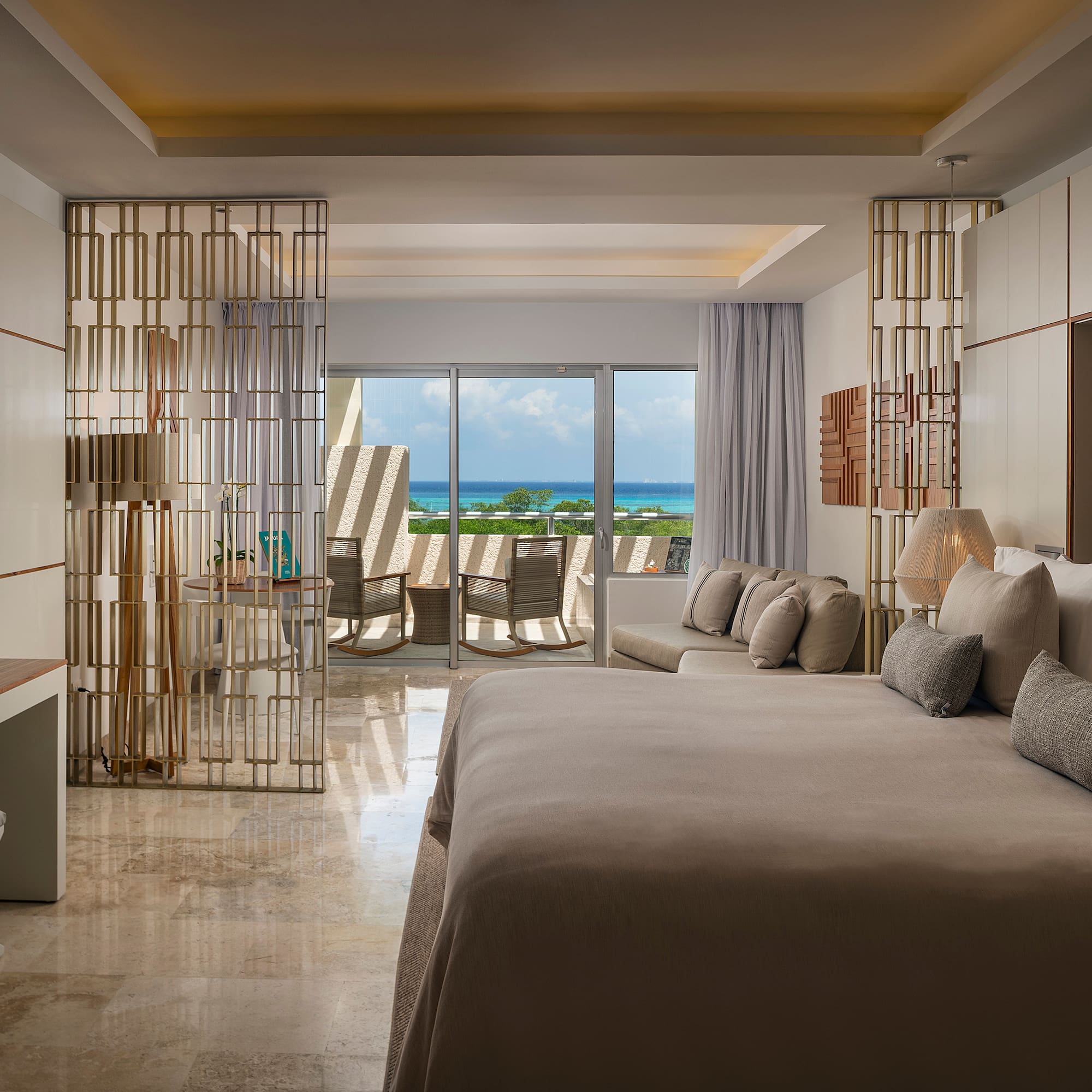 a room with a bed and a table and chairs