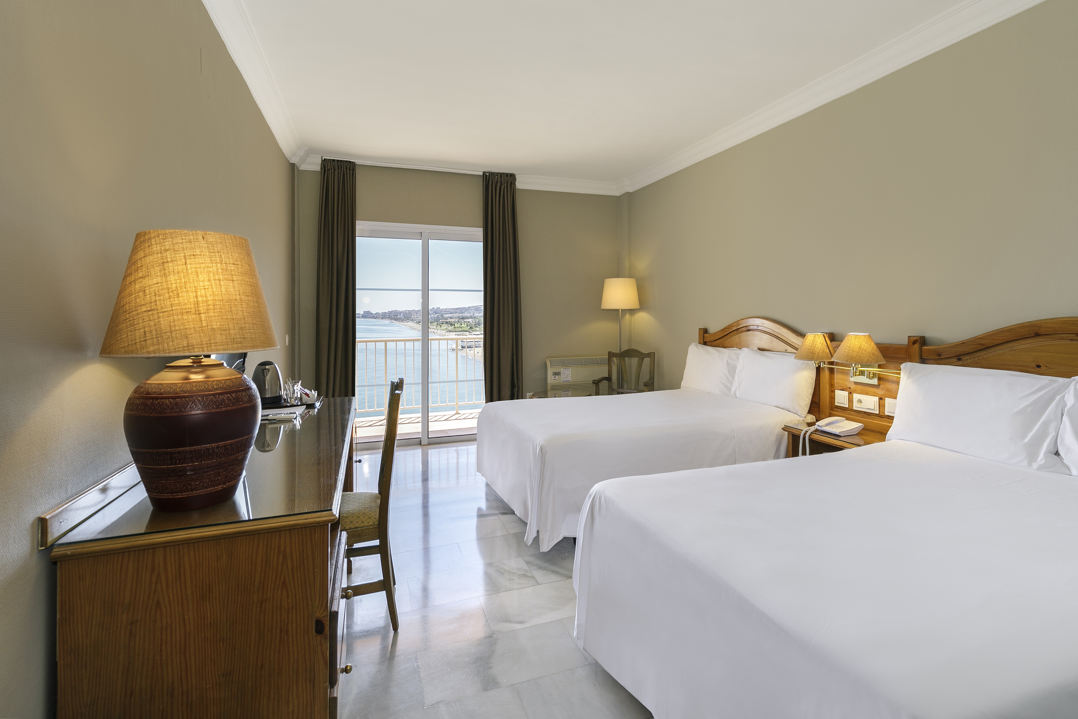 a room with two beds and a desk