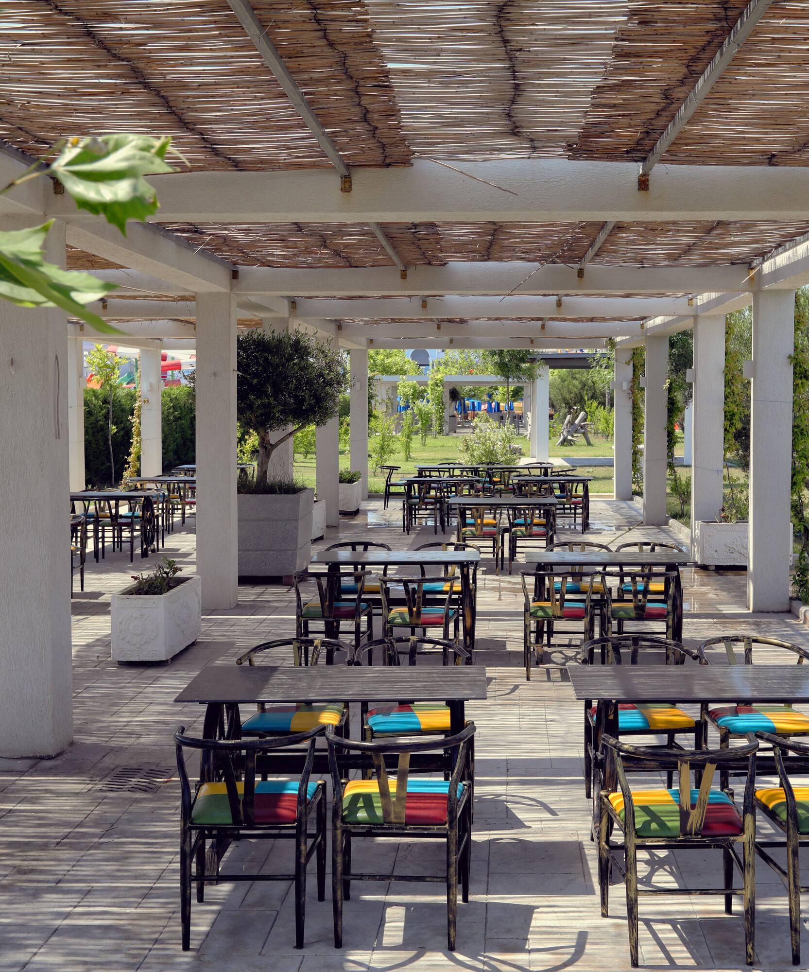 a patio with tables and chairs