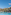 Tropical resort pool, palm trees, elegant hotel, and mountains.