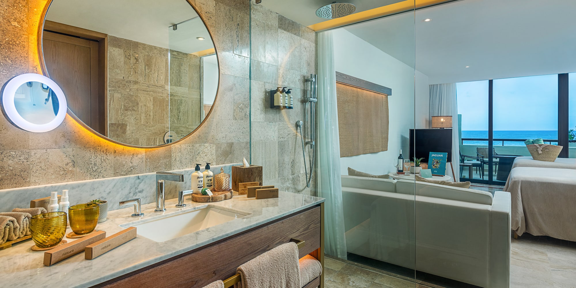 a bathroom with a large round mirror and a bathtub