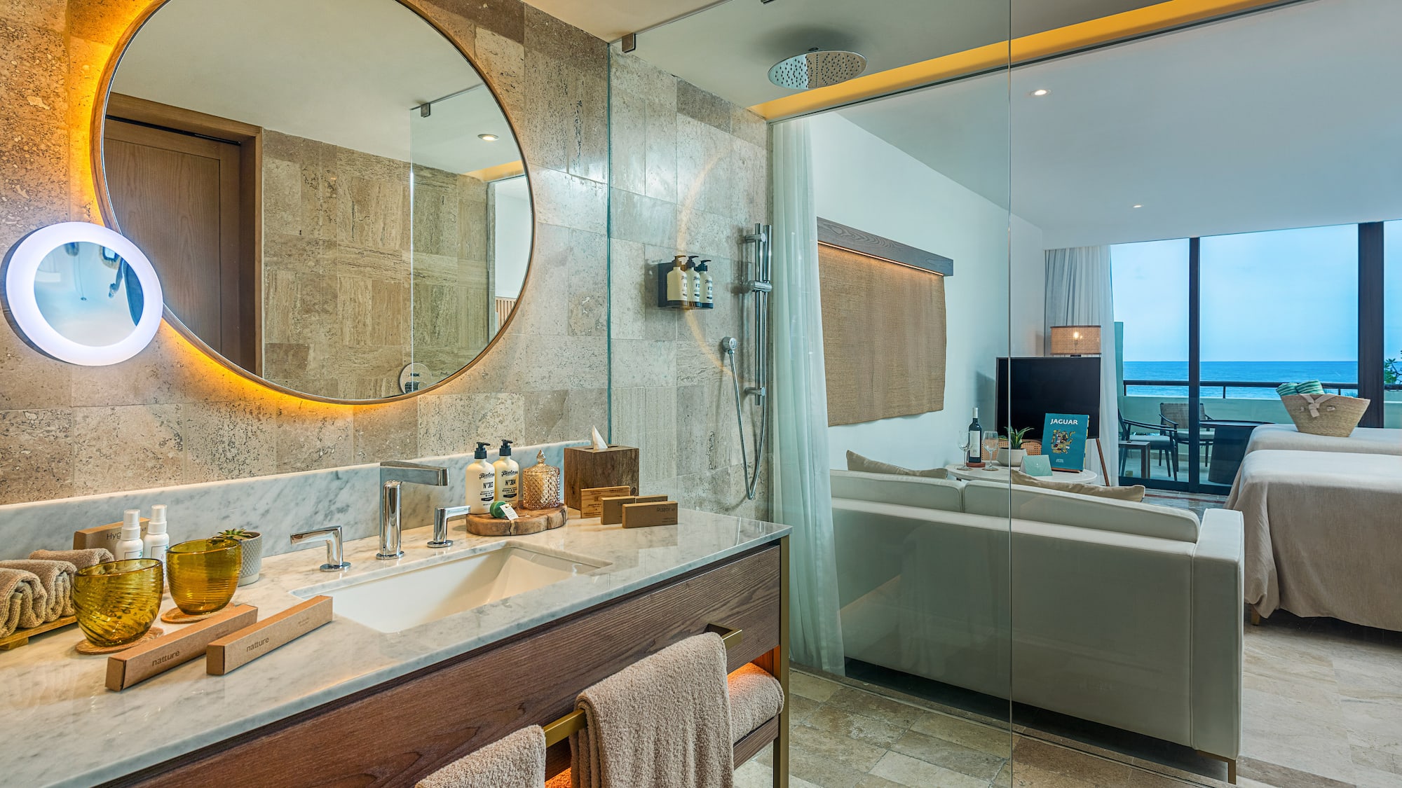 a bathroom with a large round mirror and a bathtub