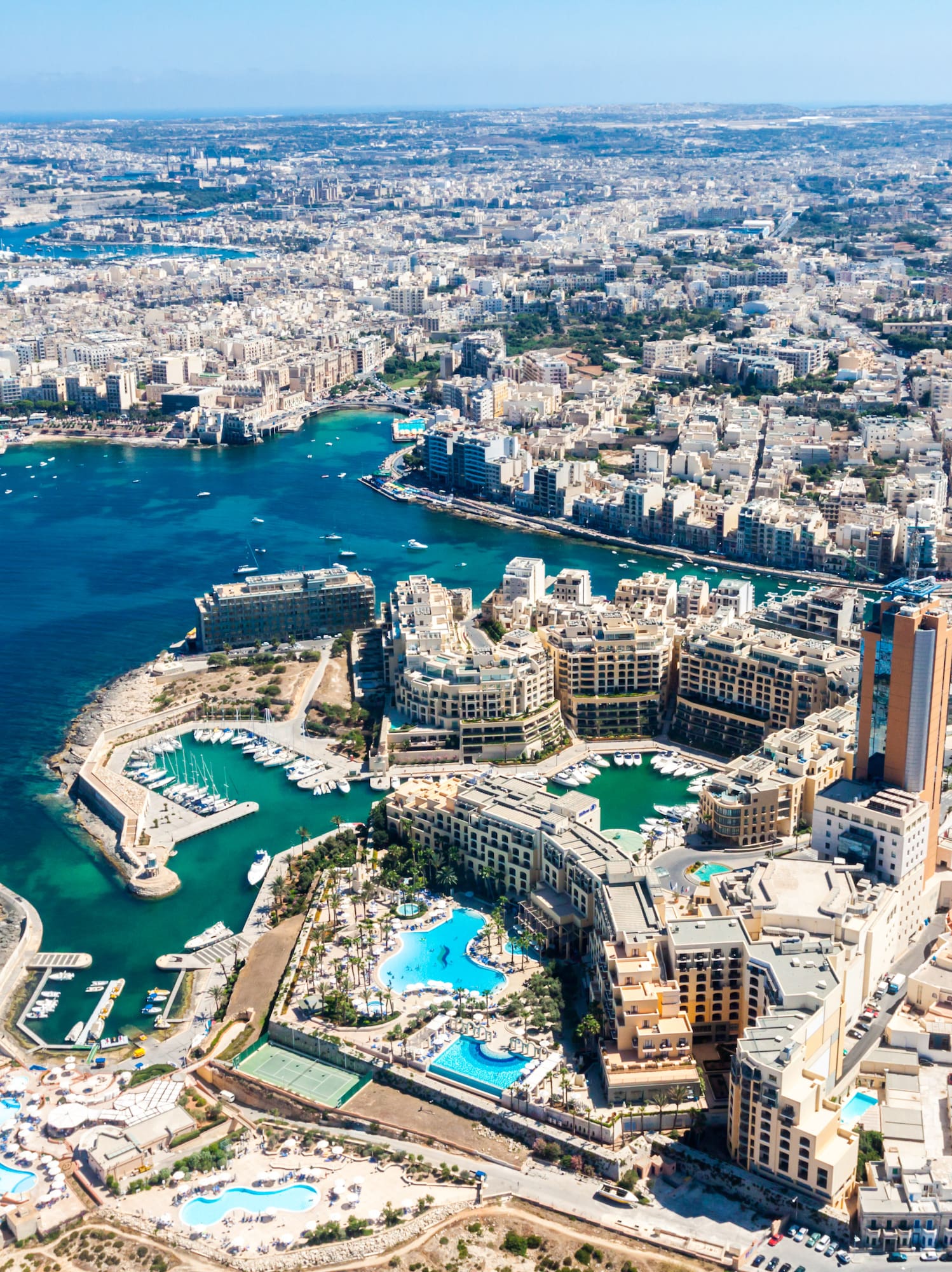 an aerial view of a city with a body of water