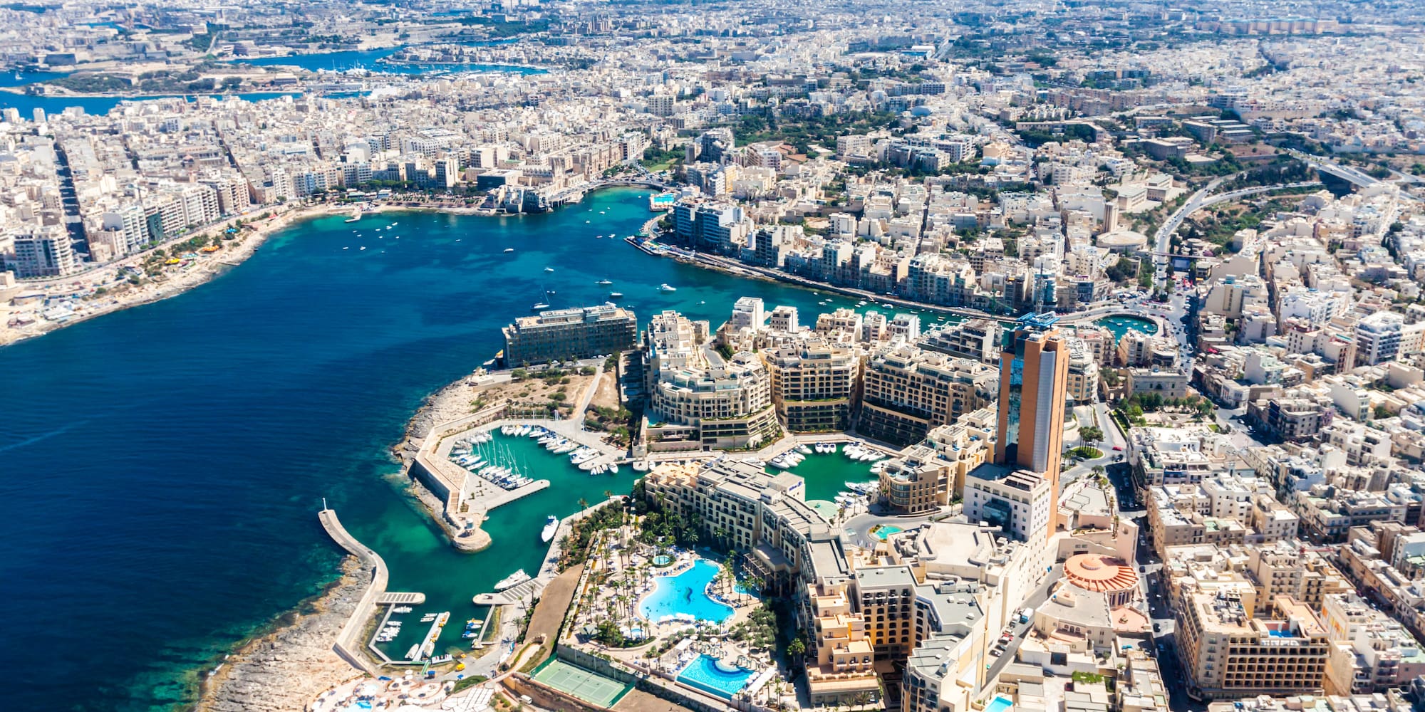 an aerial view of a city with a body of water