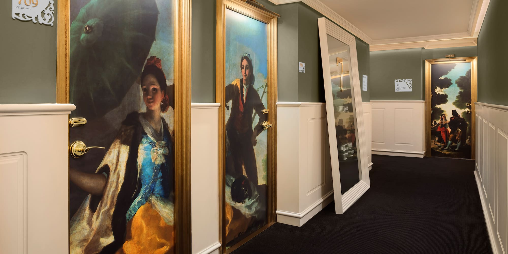 a hallway with paintings on the wall