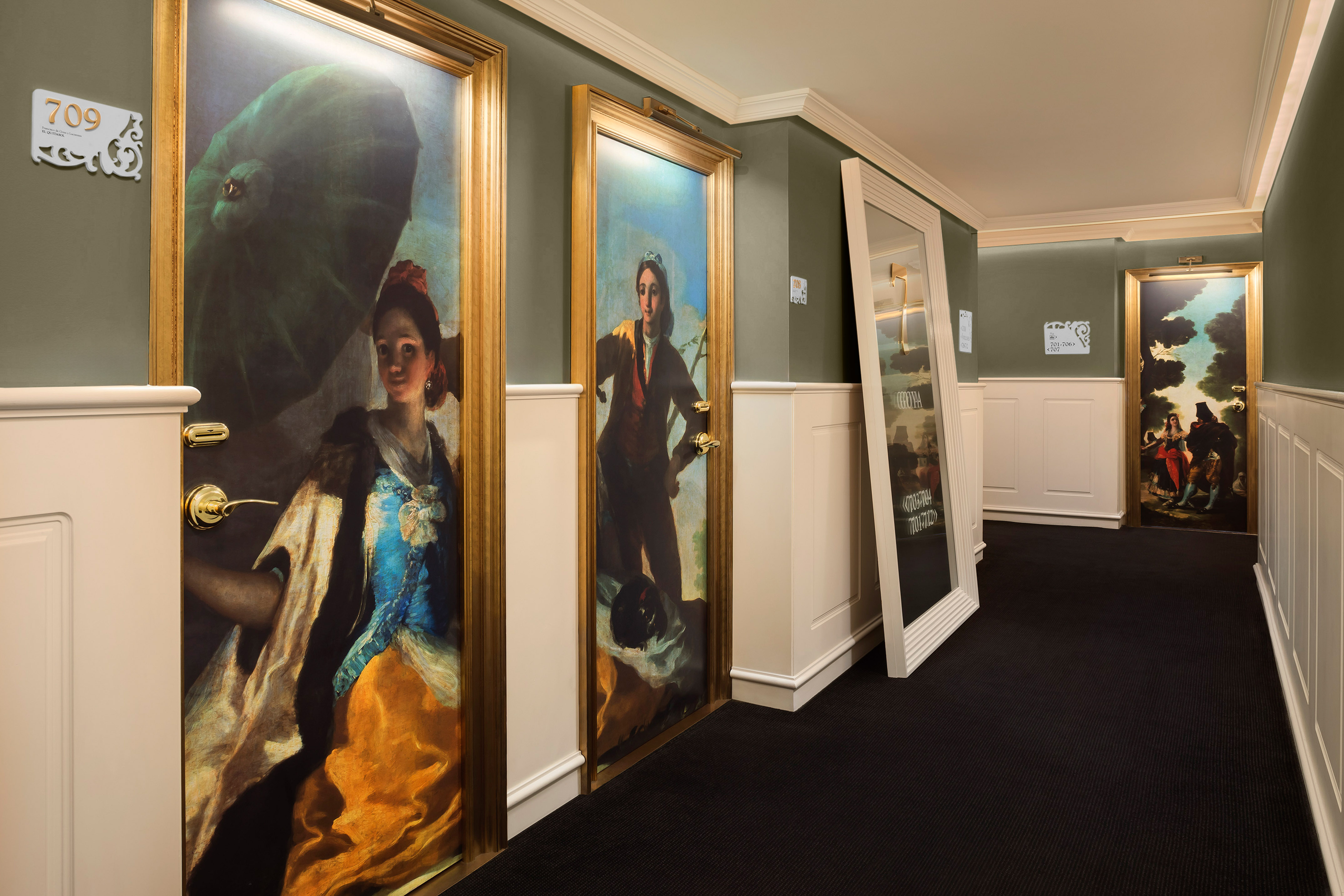 a hallway with paintings on the wall