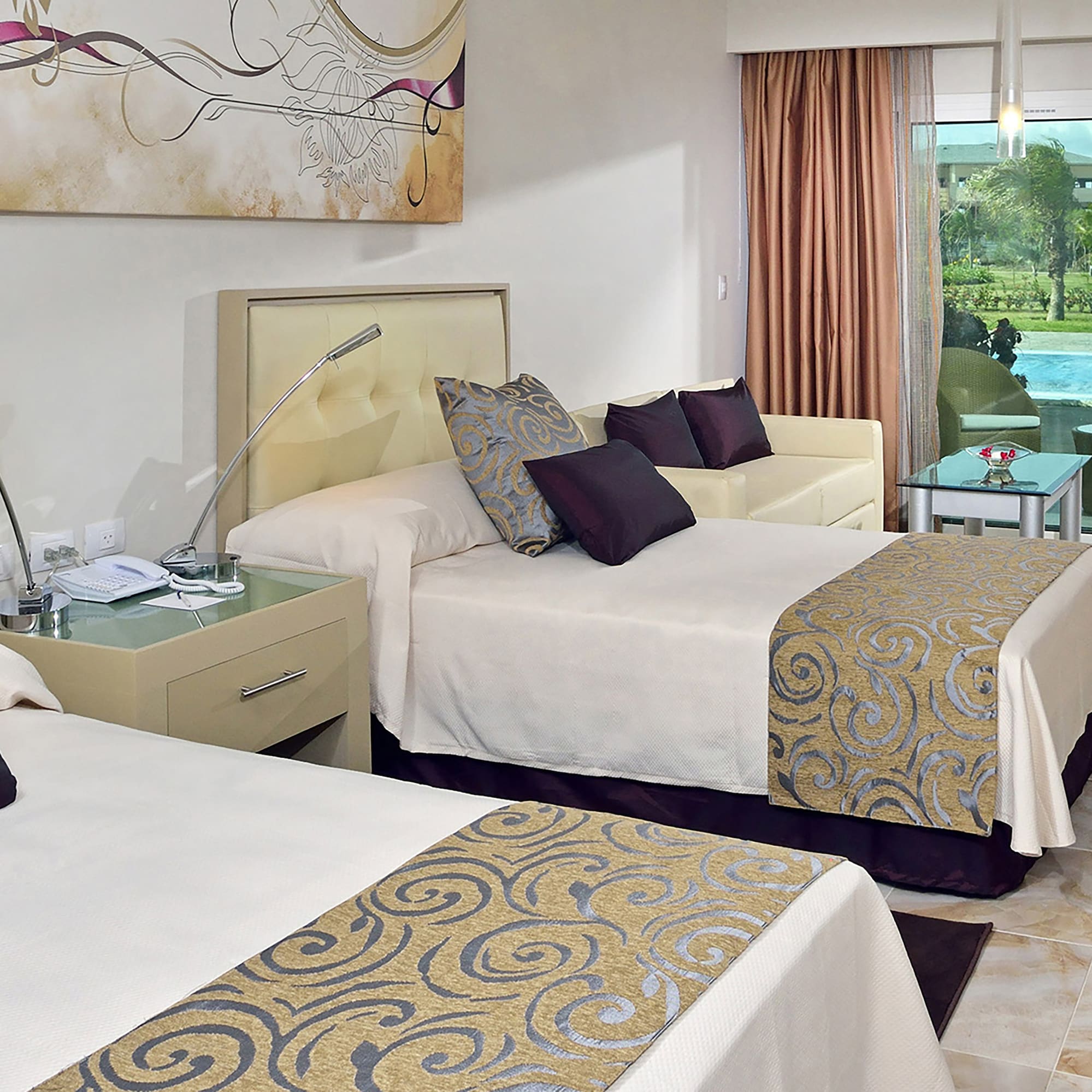 a room with two beds and a pool in the background