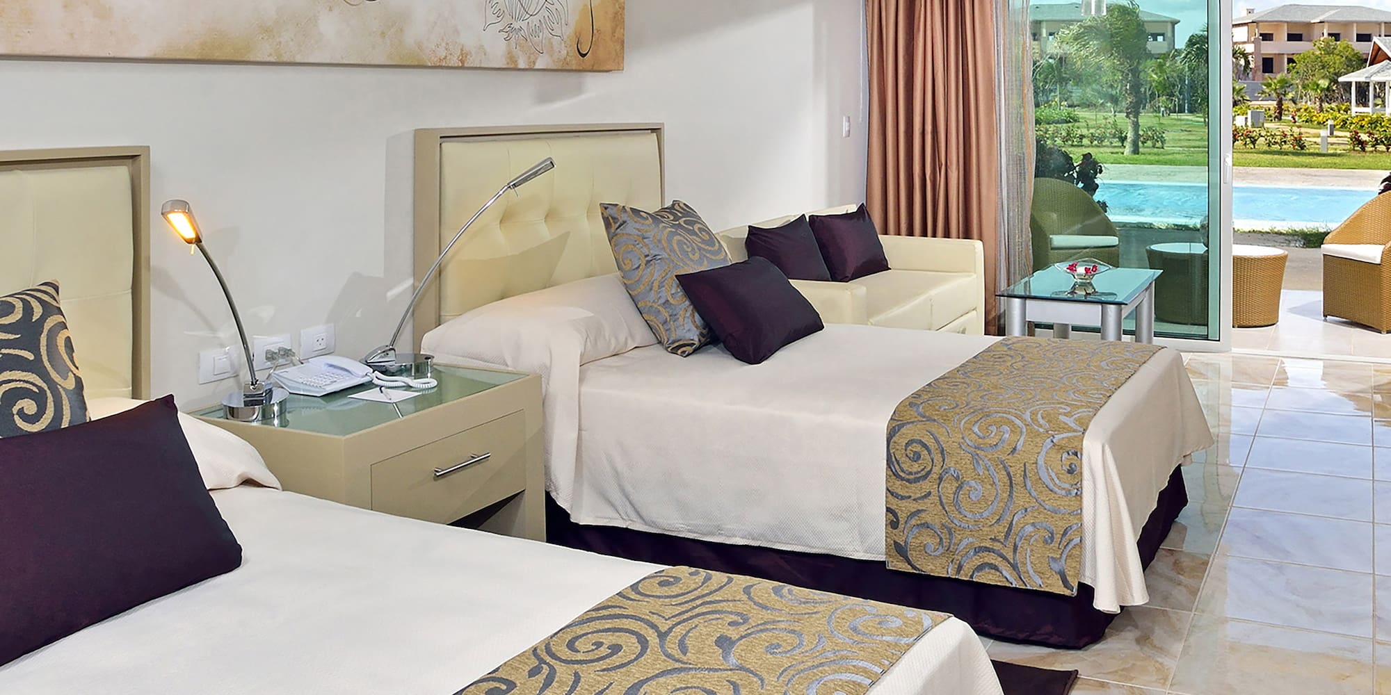 a room with two beds and a pool in the background