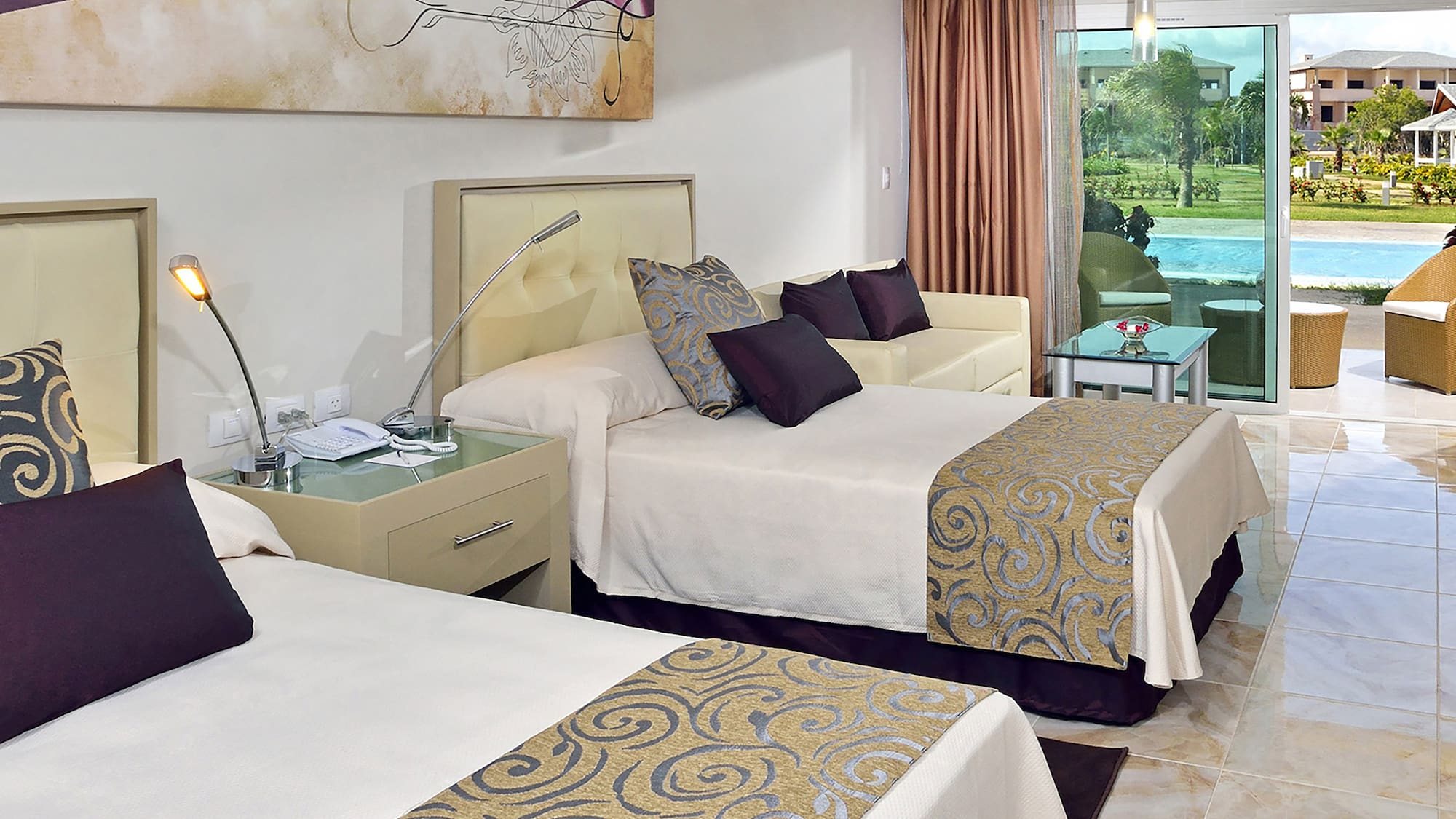 a room with two beds and a pool in the background