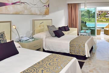 a room with two beds and a pool in the background