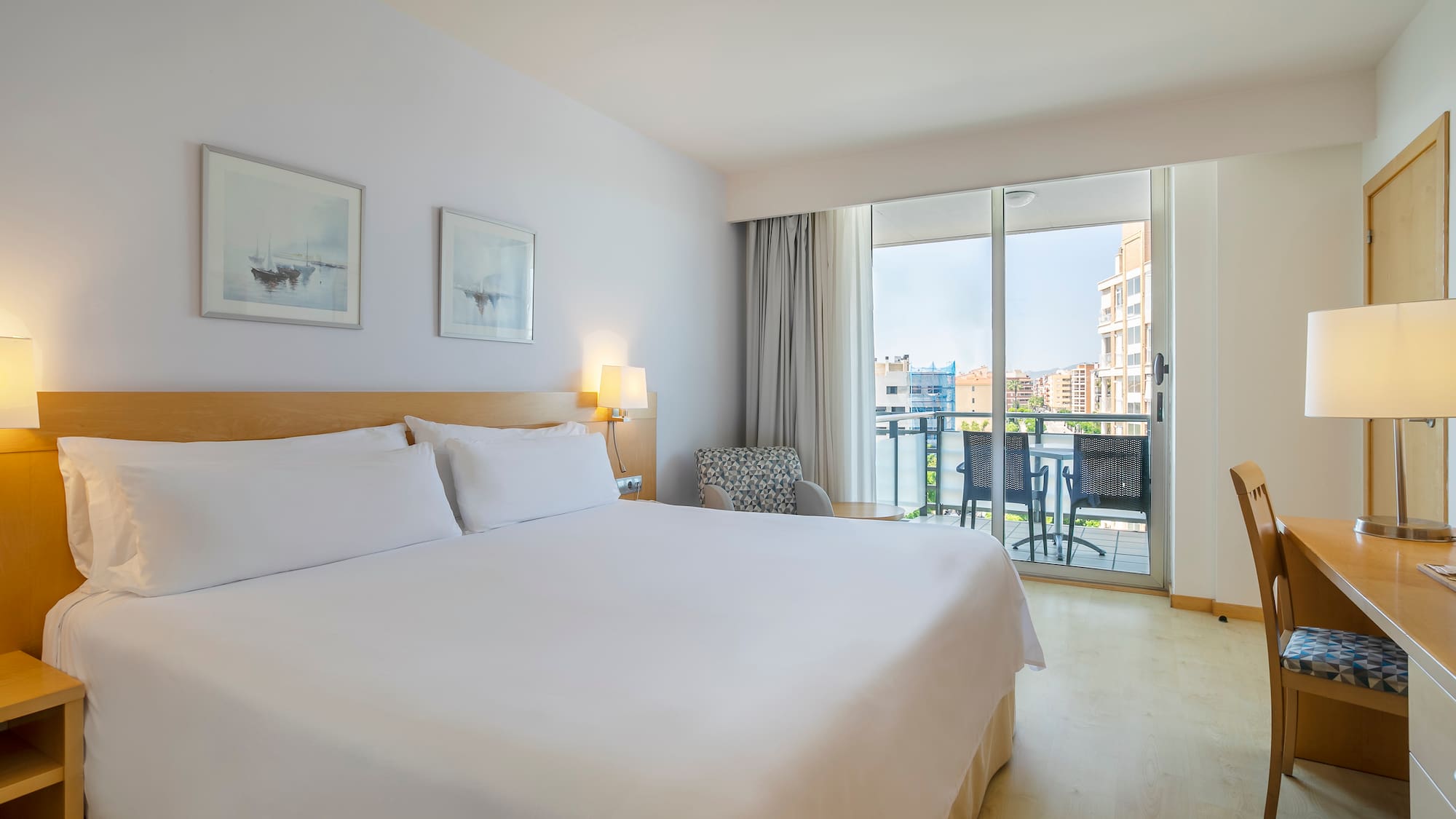 a bed in a room with a balcony