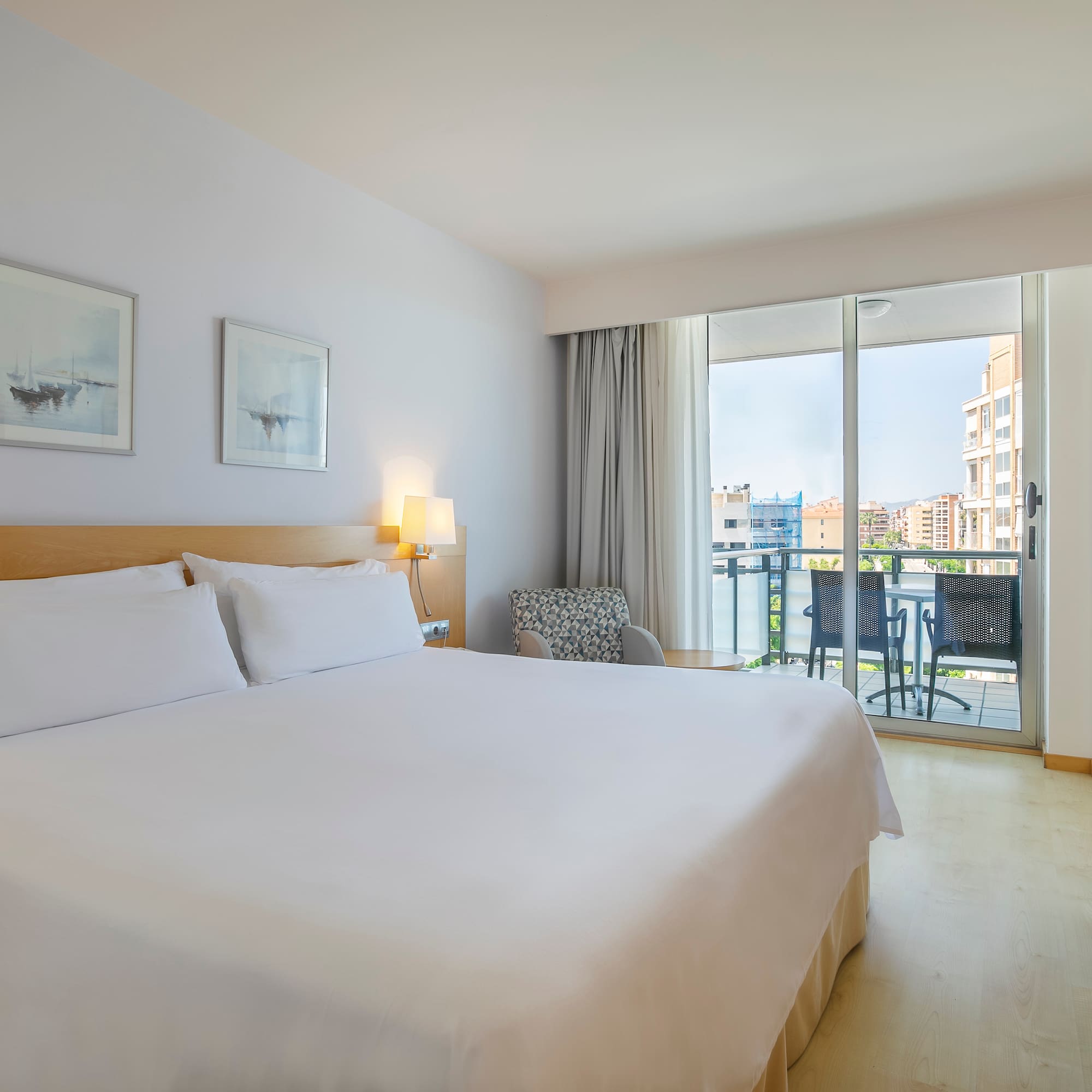 a bed in a room with a balcony