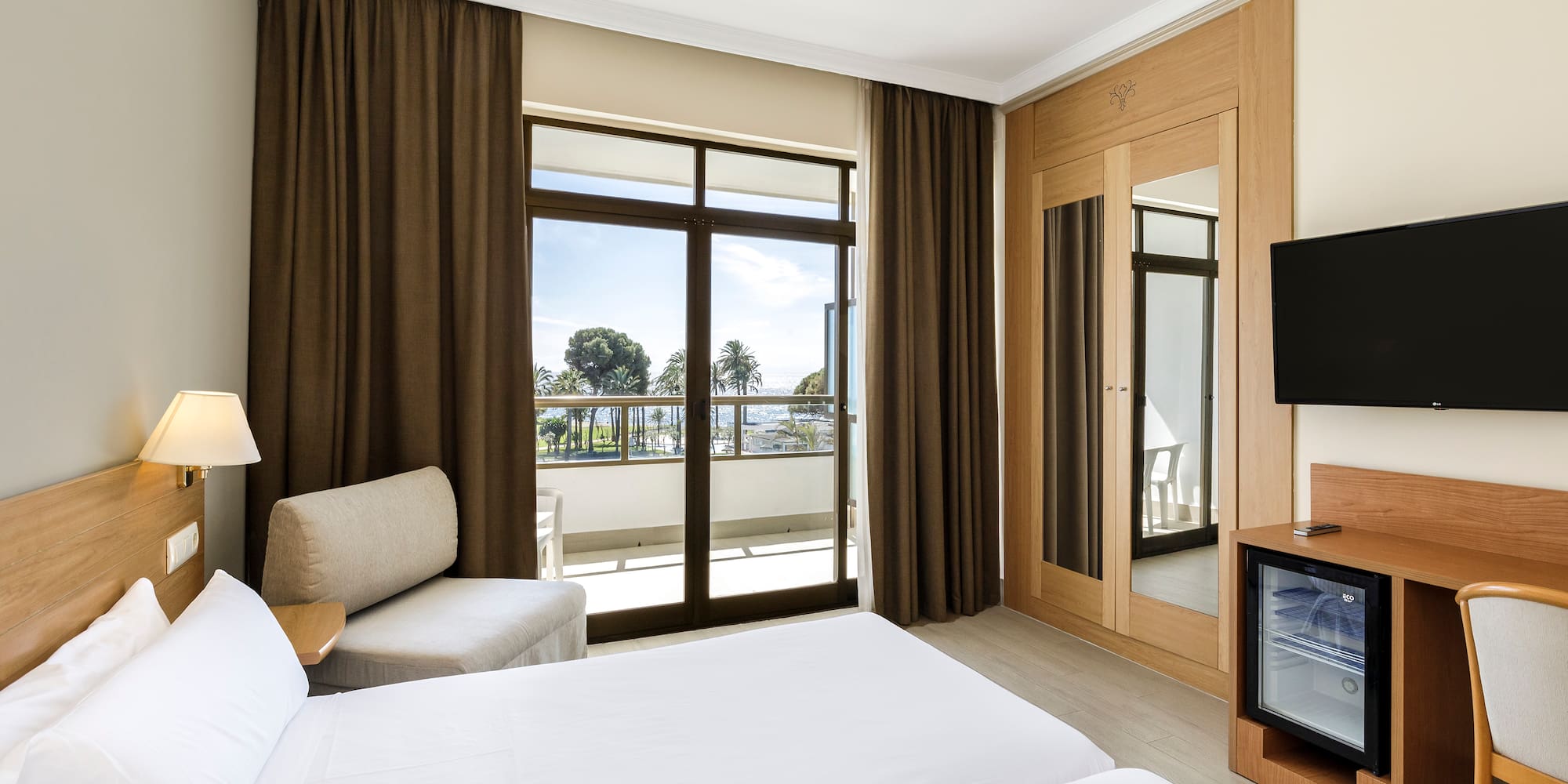 a room with a television and two beds