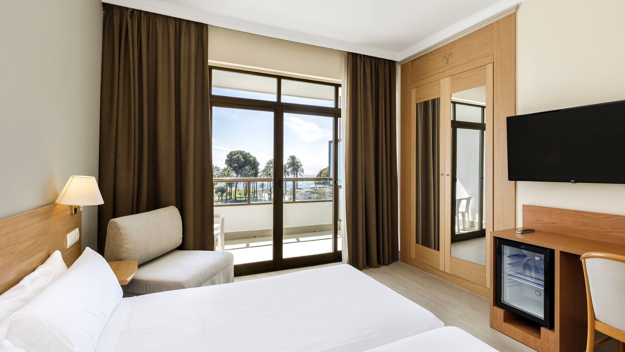 a room with a television and two beds