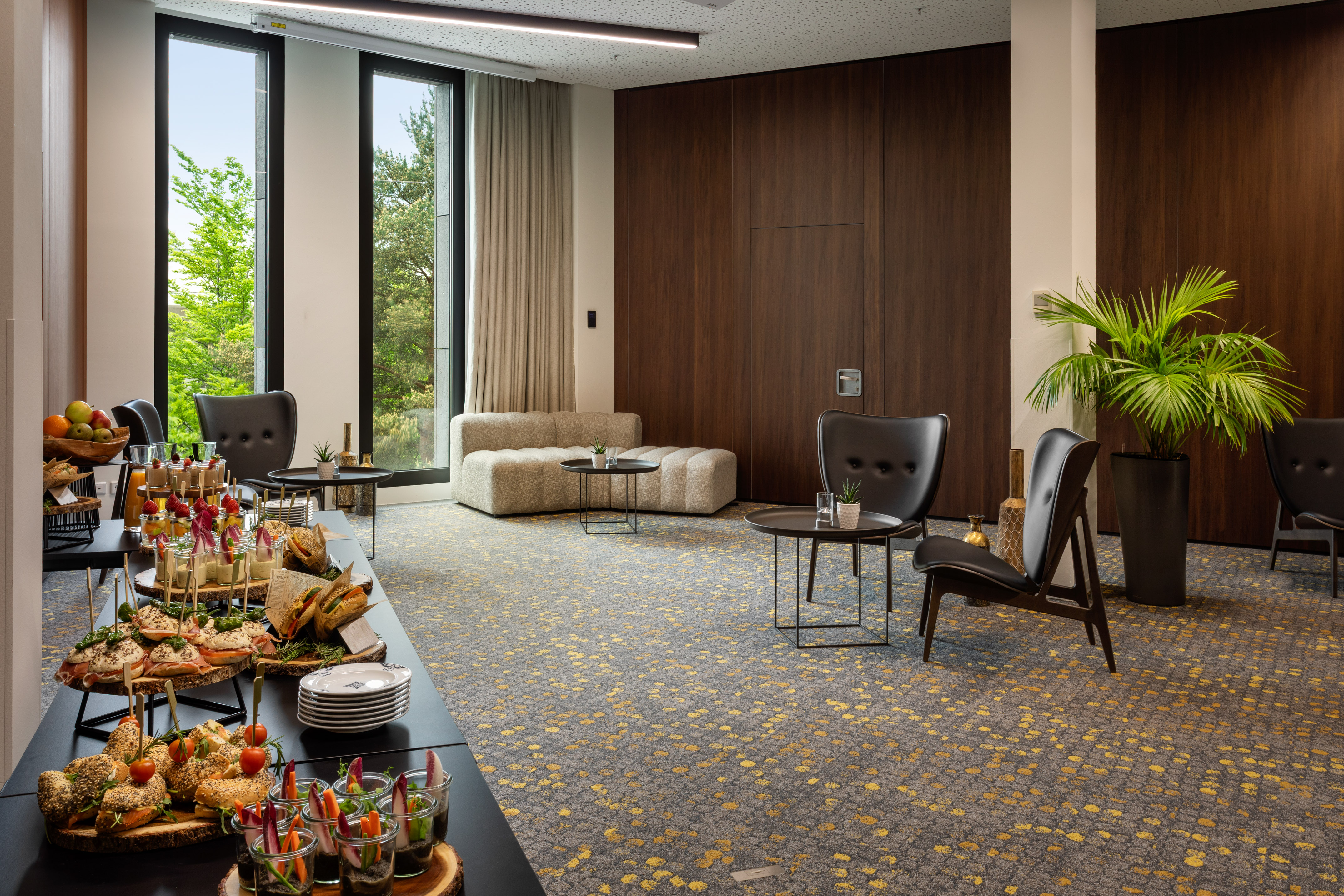 a room with a table of food and chairs