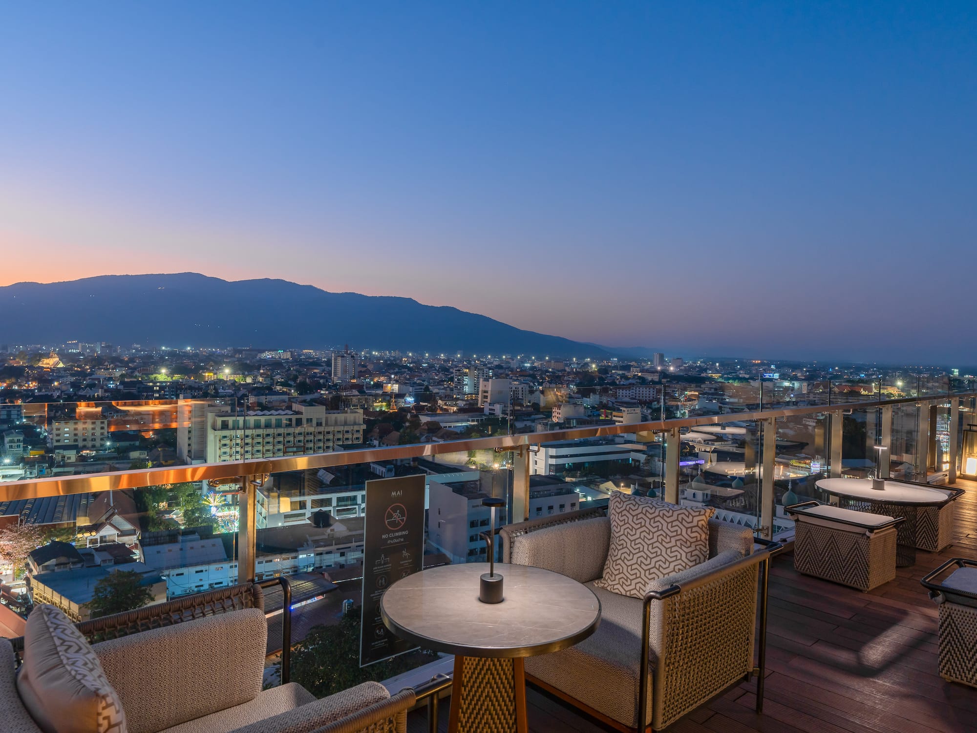a table and chairs on a rooftop overlooking a city