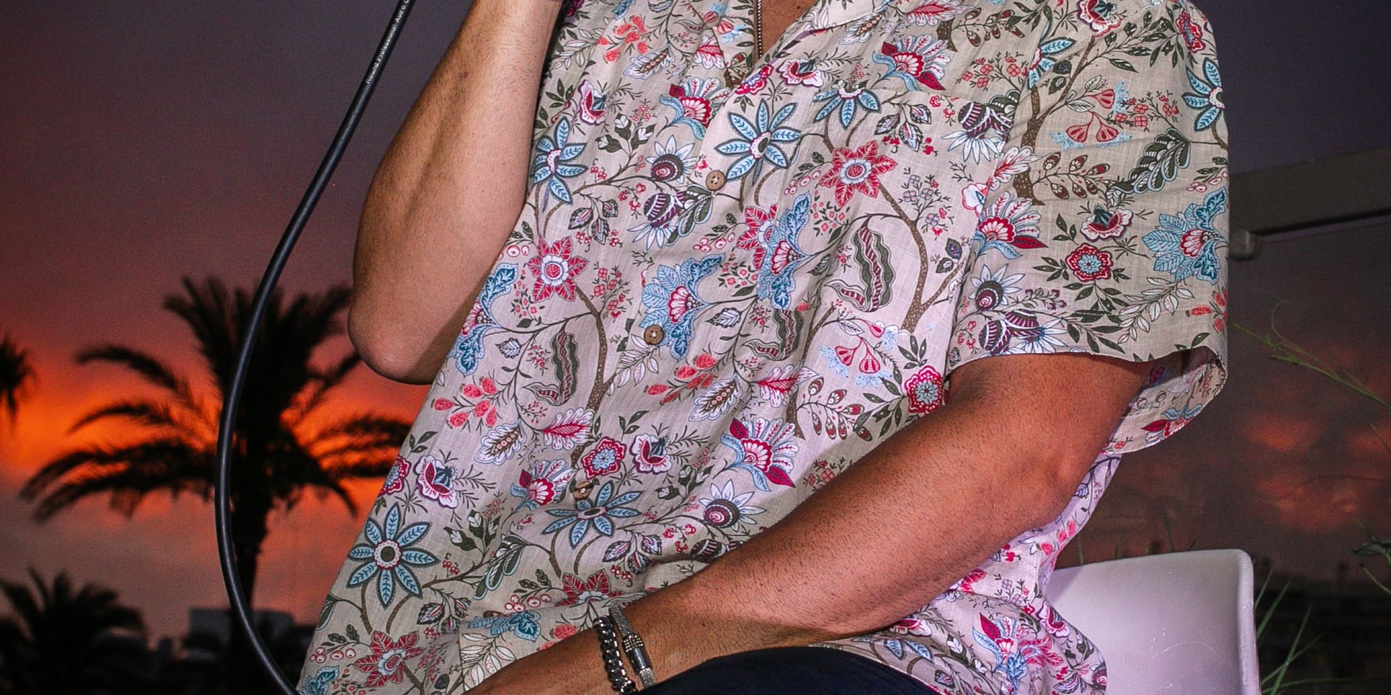 a man sitting on a chair holding a microphone