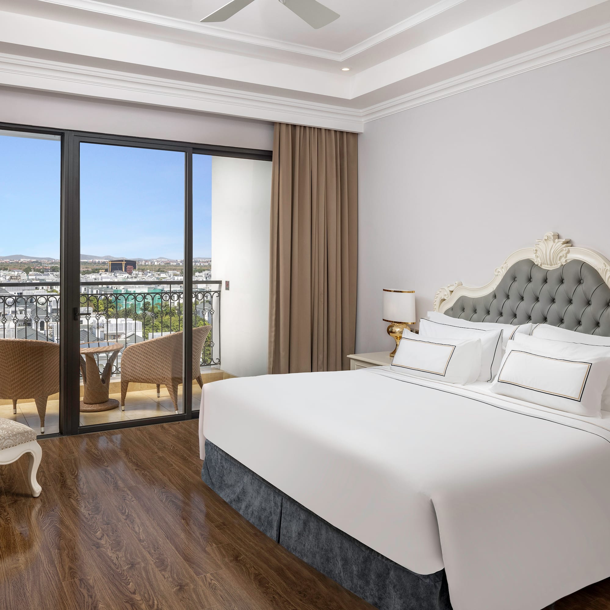 a bedroom with a large window and a balcony