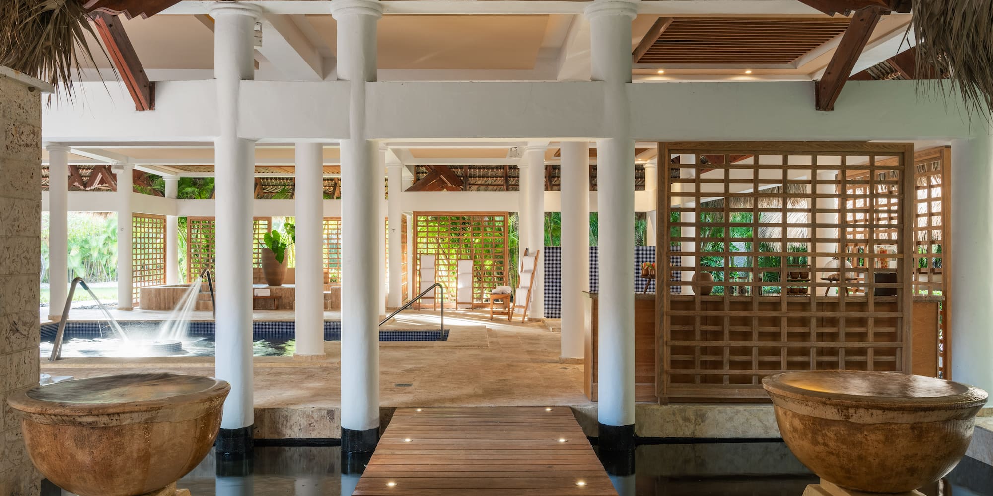 a room with a pool and water fountain