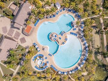 a swimming pool with chairs and a pool in the middle