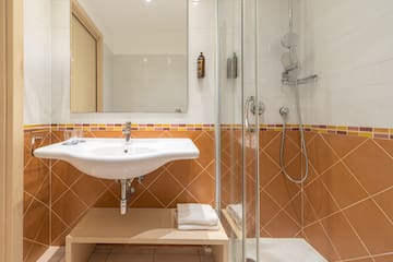 a bathroom with a shower and sink