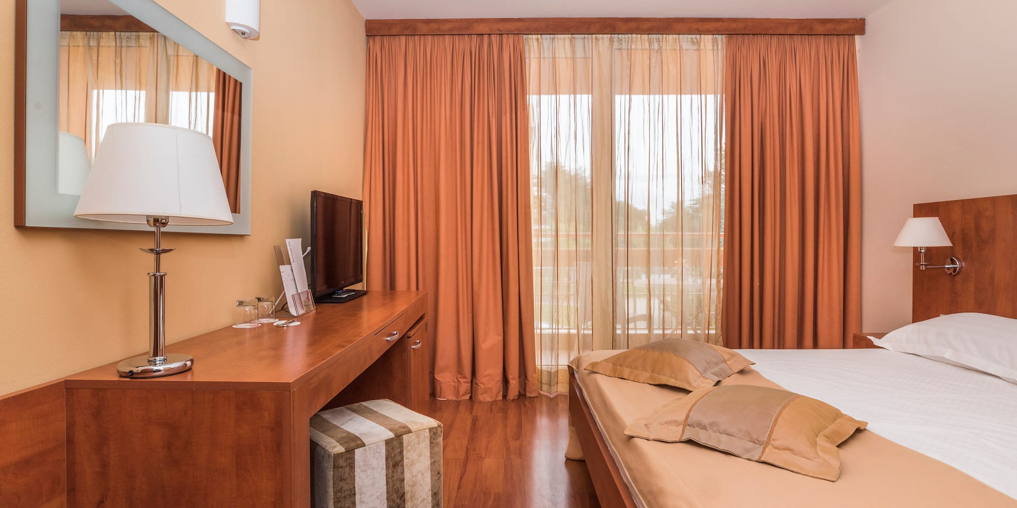 a bedroom with a bed and a desk