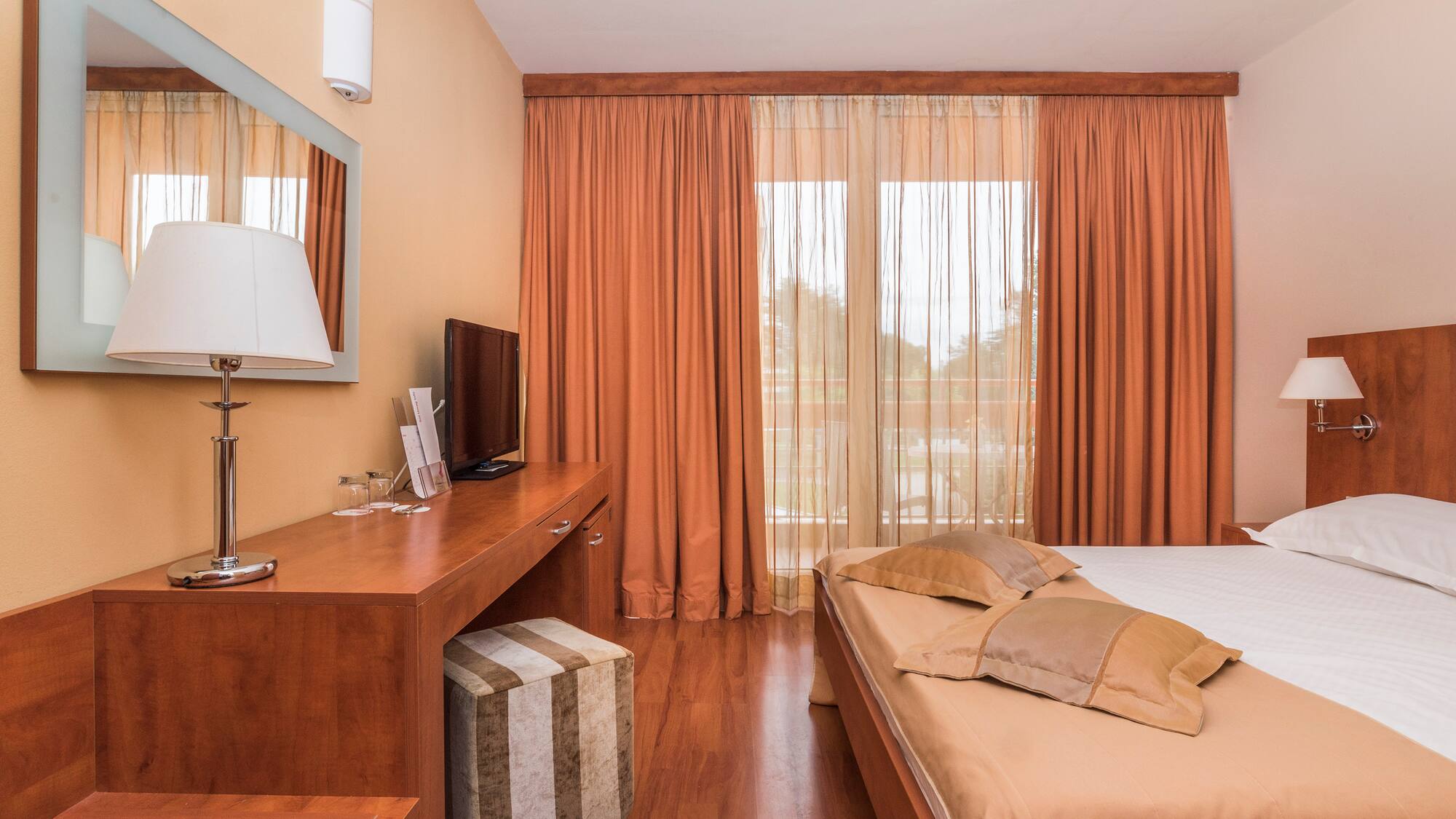 a bedroom with a bed and a desk