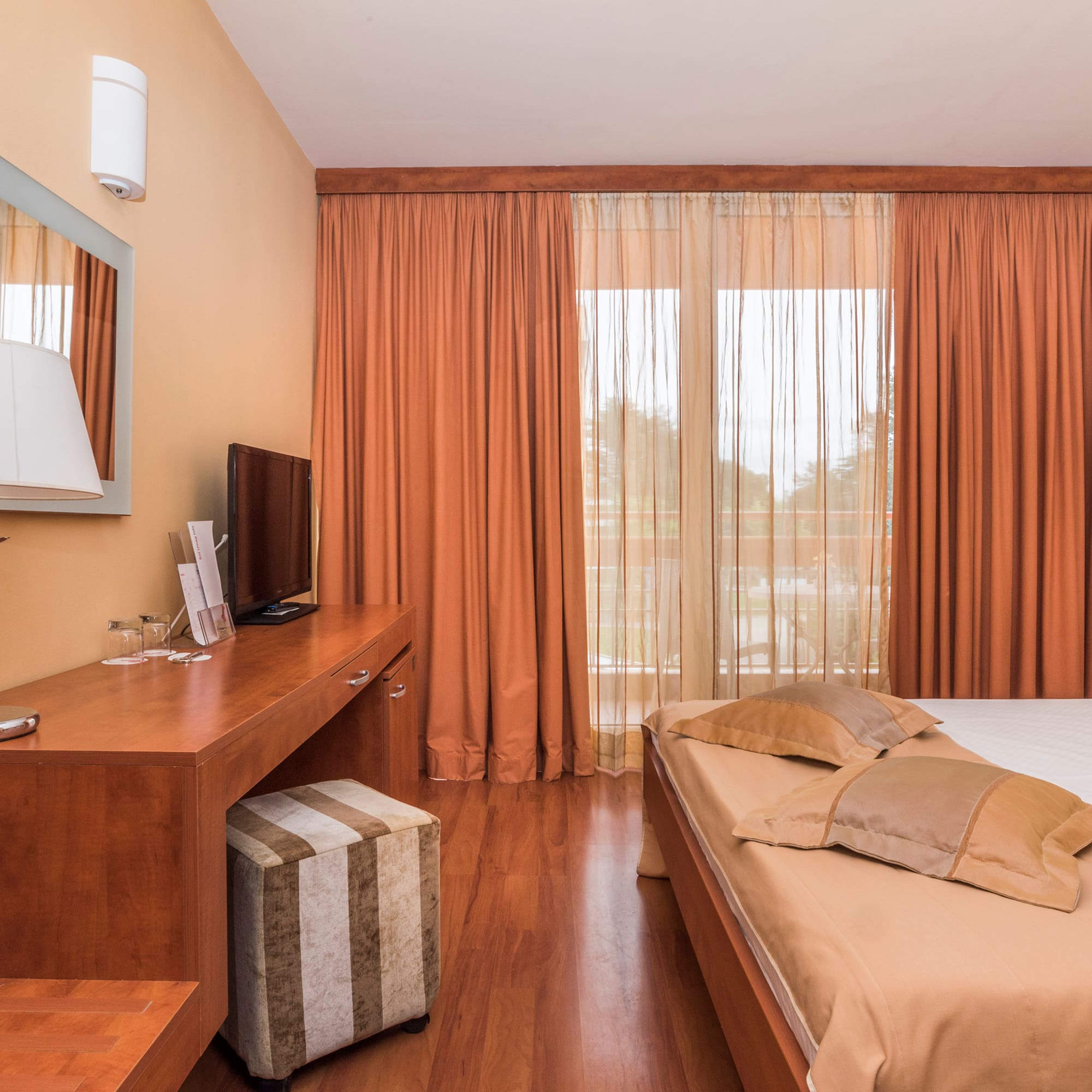 a bedroom with a bed and a desk