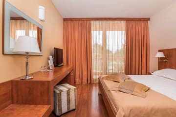 a bedroom with a bed and a desk