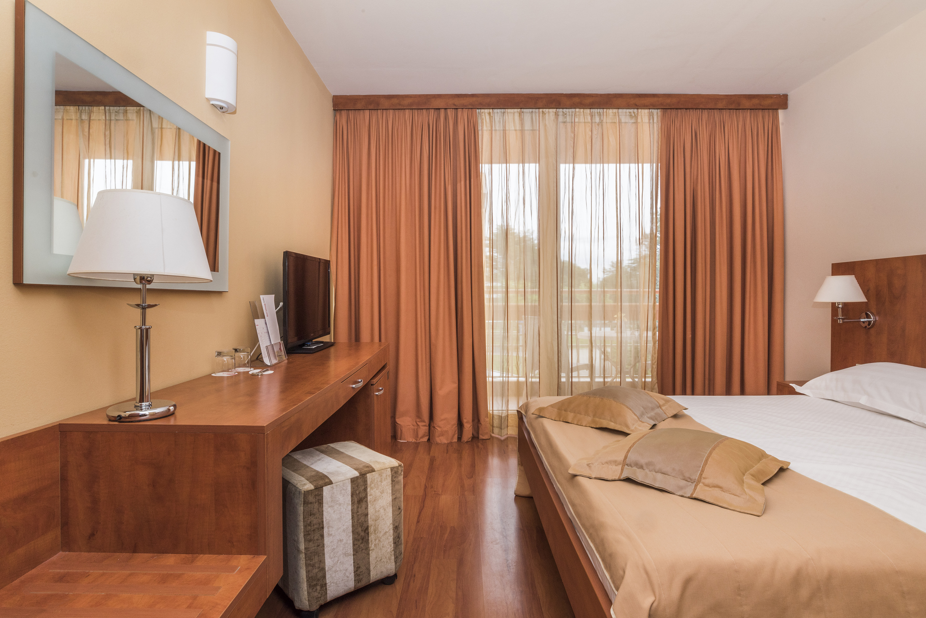 a bedroom with a bed and a desk