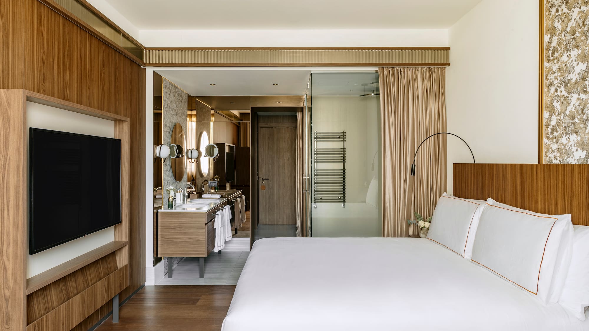 a bedroom with a television and a bed