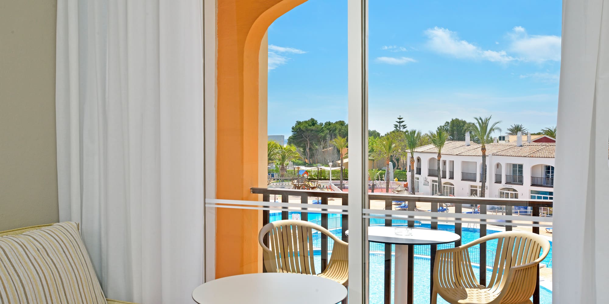 a room with a pool and chairs