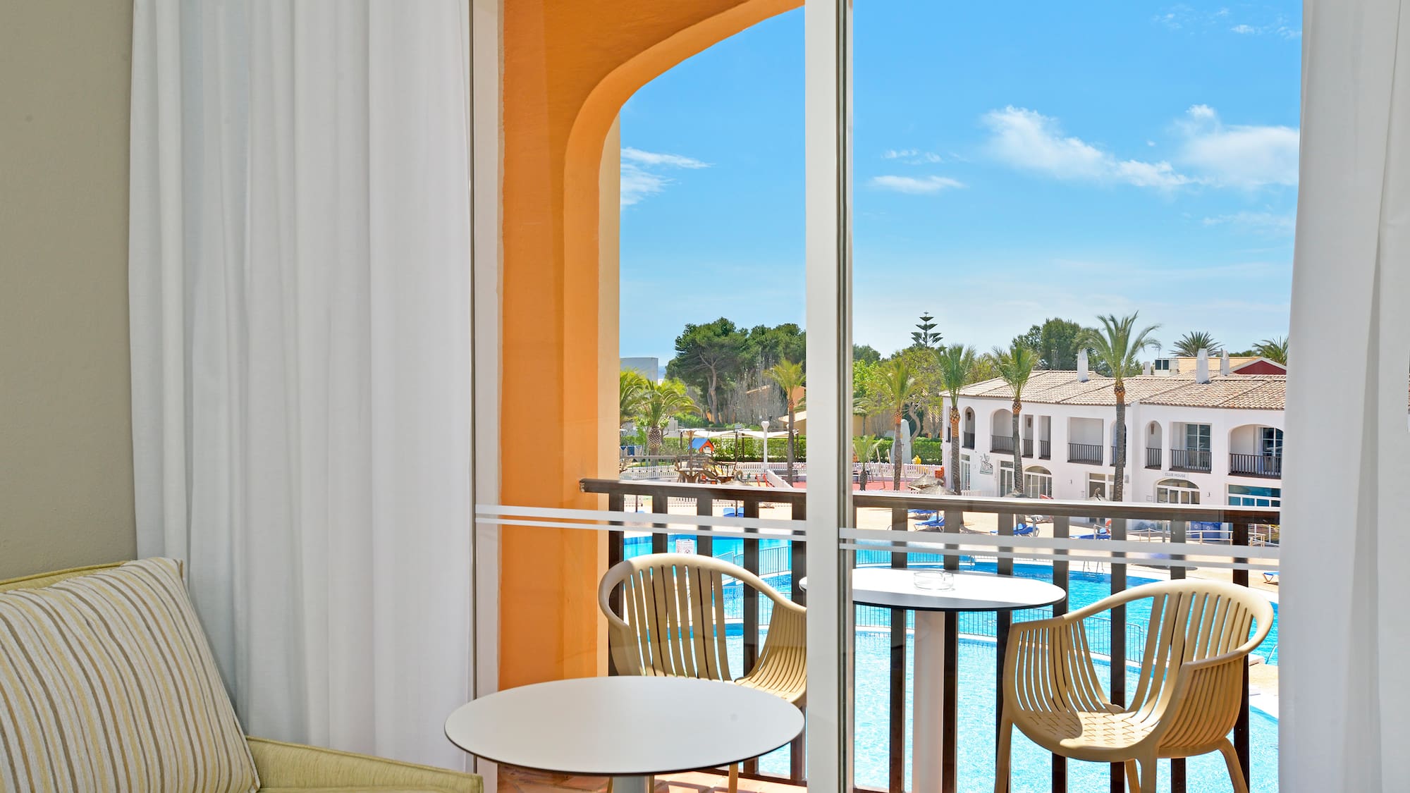 a room with a pool and chairs