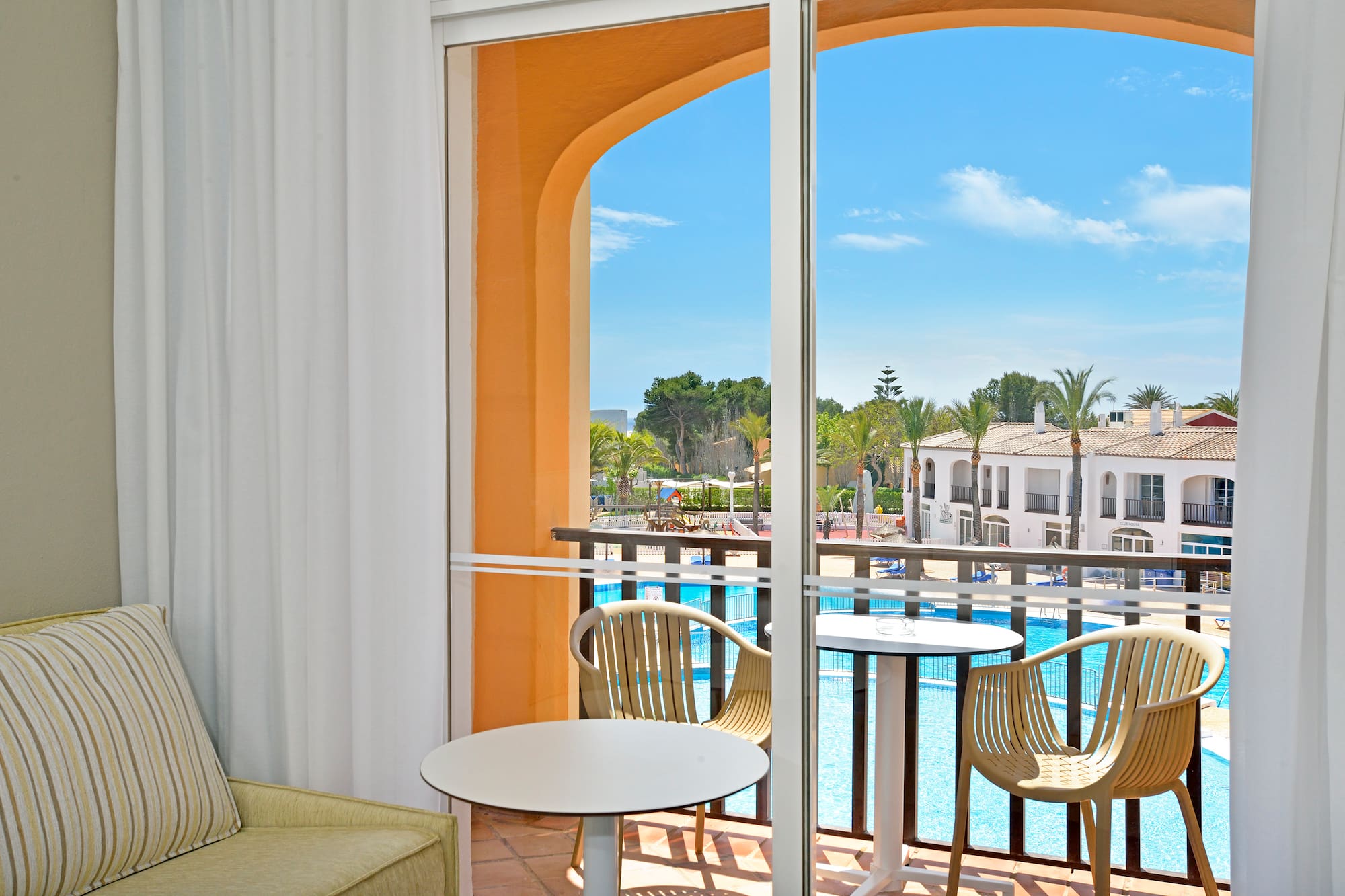 a room with a pool and chairs