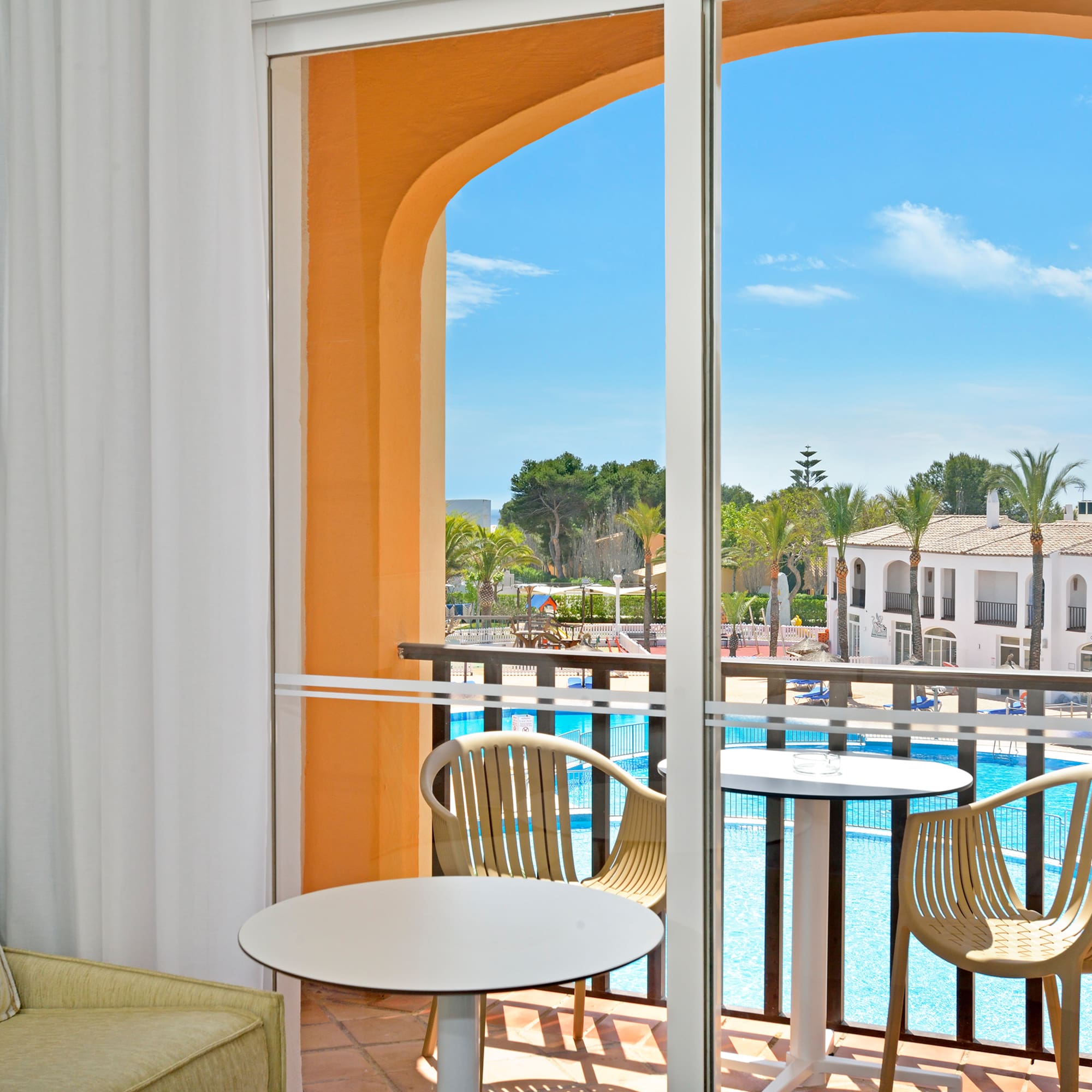 a room with a pool and chairs
