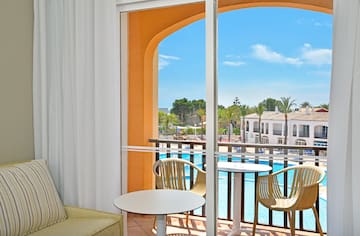 a room with a pool and chairs