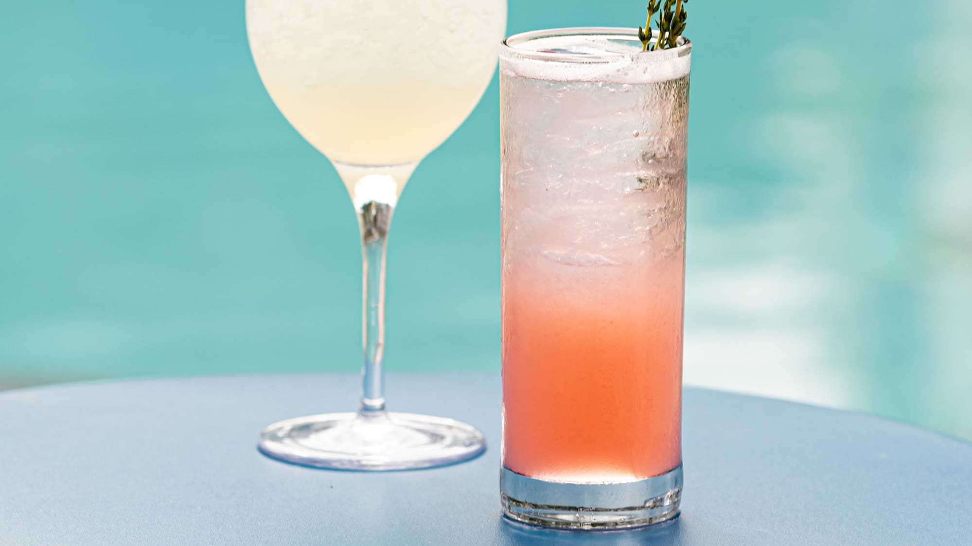 two glasses of drinks on a table