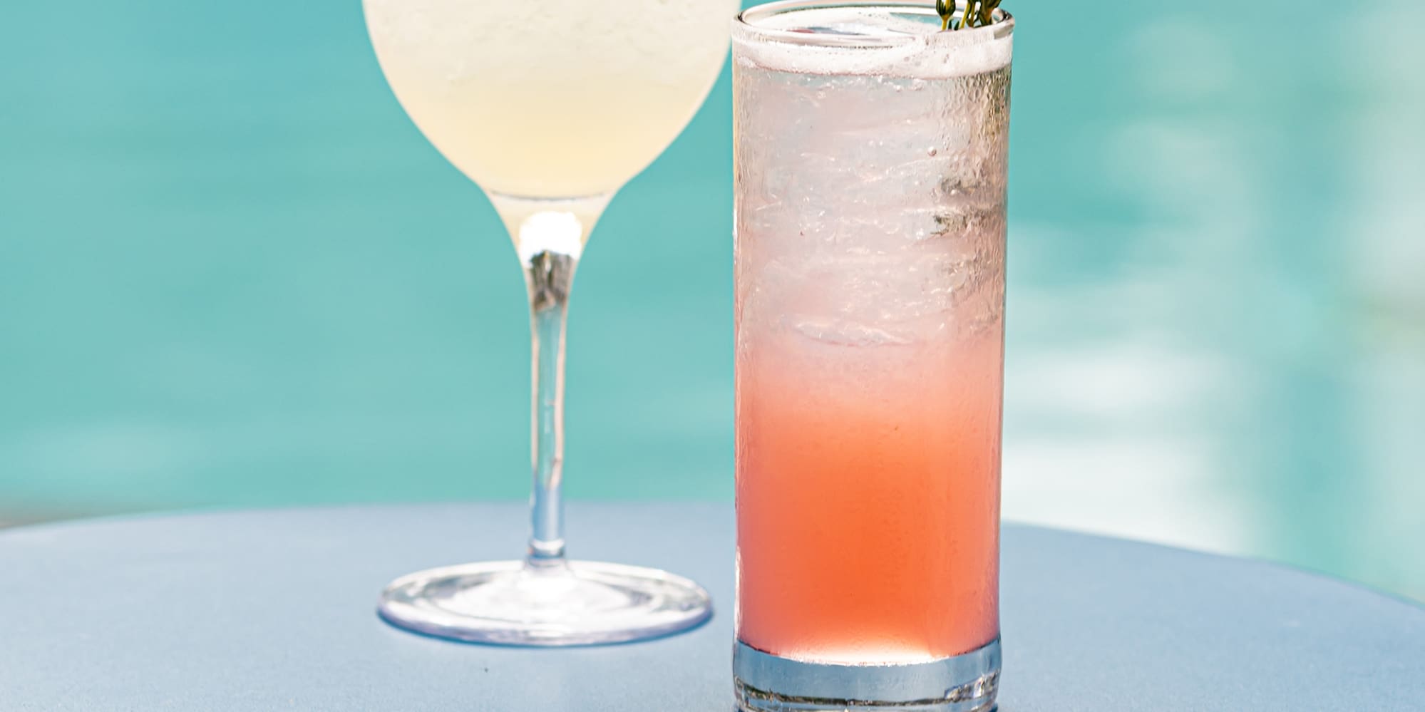 two glasses of drinks on a table