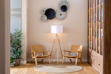 a room with two chairs and a lamp