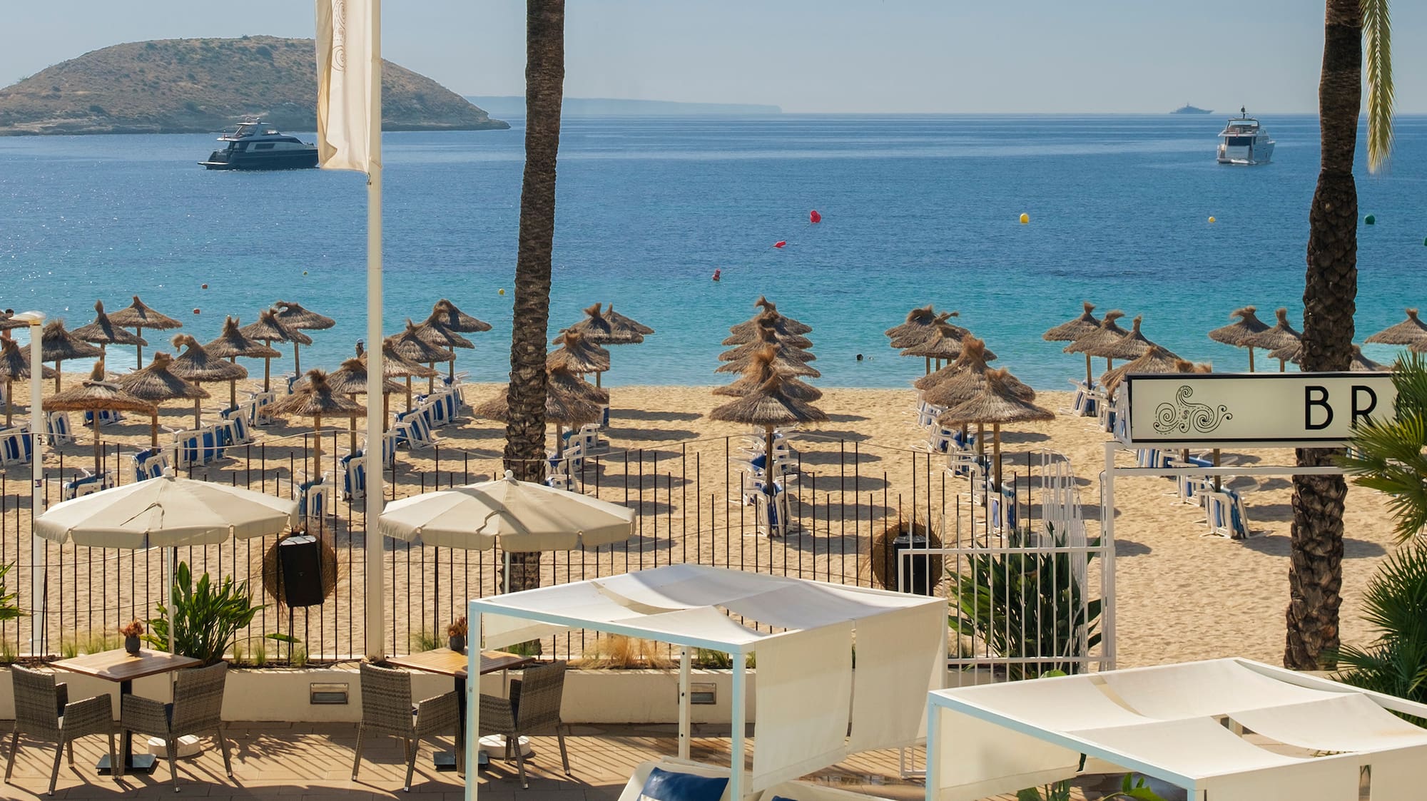 a pool with umbrellas and chairs on a beach