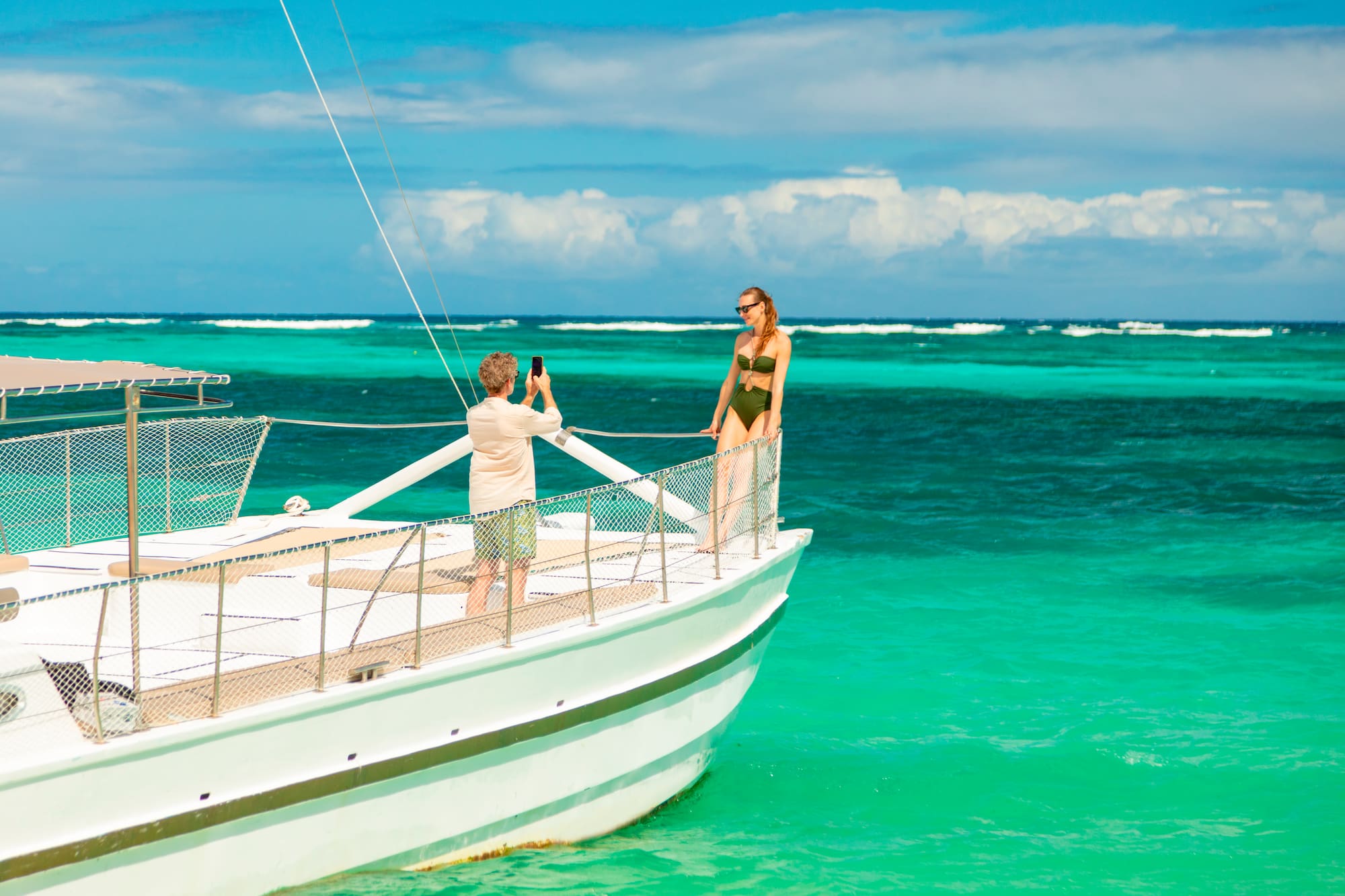 a man taking a picture of a woman on a boat