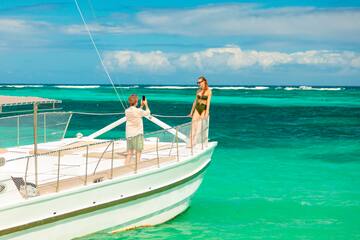 a man taking a picture of a woman on a boat