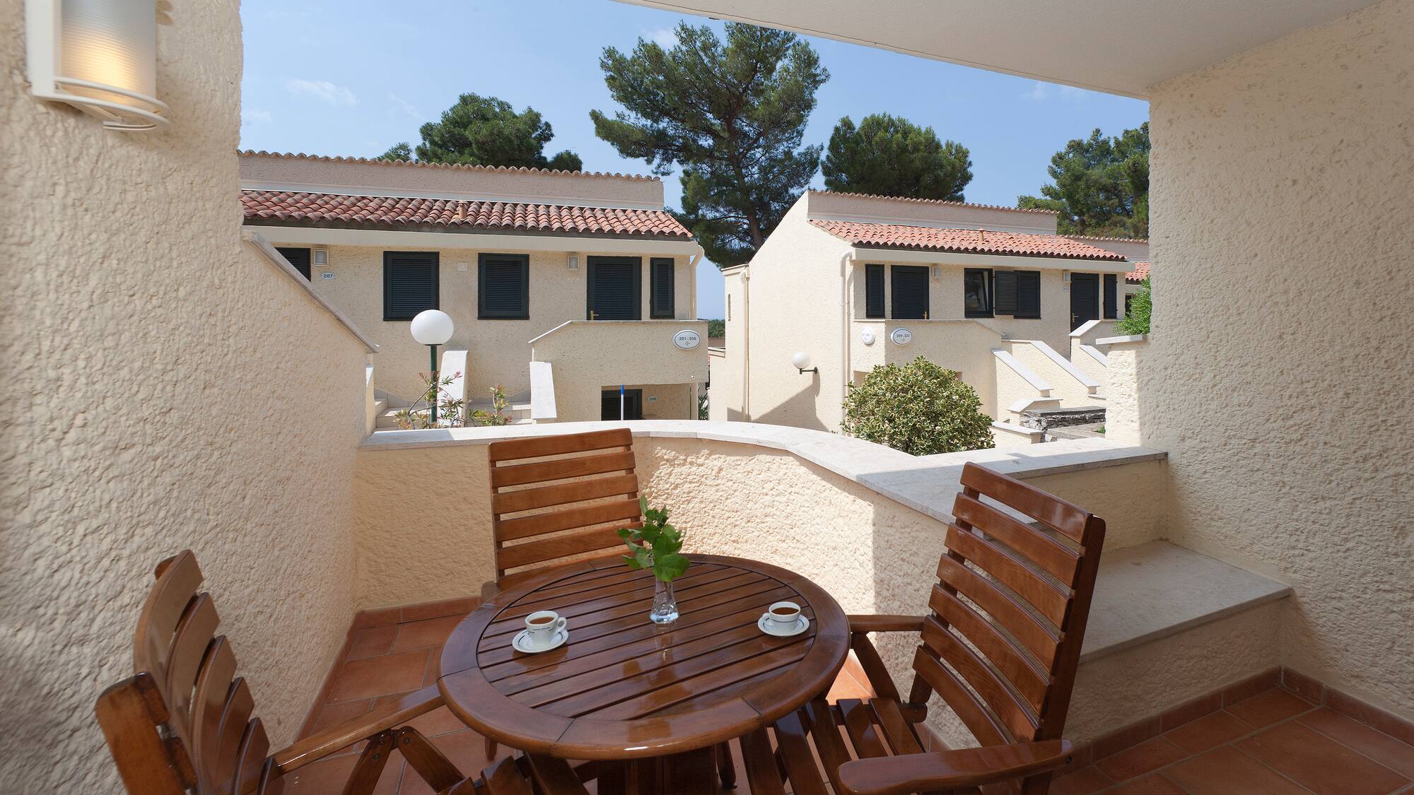 a table and chairs on a balcony