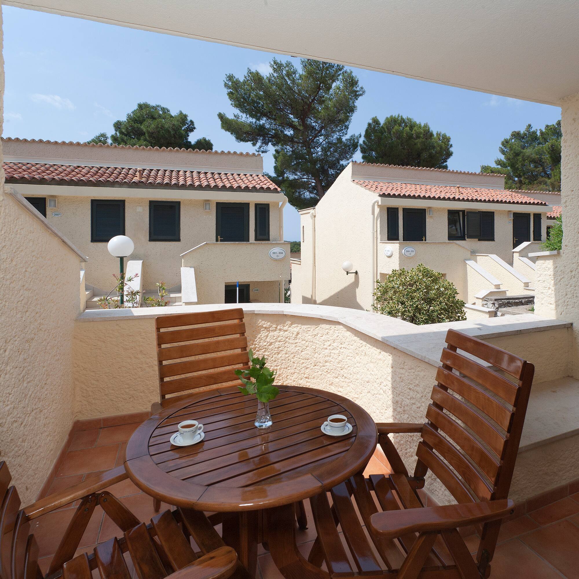 a table and chairs on a balcony